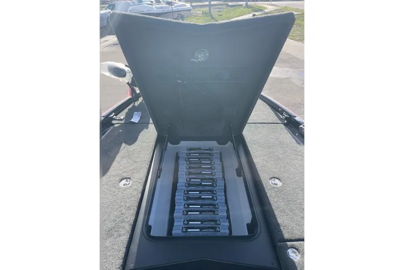 Slide: The Image of Open storage compartment of 2026 Skeeter FXR20 FLEX boat, showcasing organized battery setup. - 18