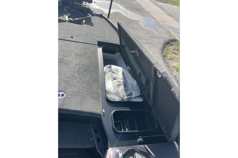 Slide: The Image of 2026 Skeeter FXR20 FLEX boat interior with open storage compartment. - 19