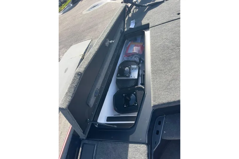 Slide: The Image of Open storage compartment in 2026 Skeeter FXR20 FLEX boat, showing organized equipment. - 20
