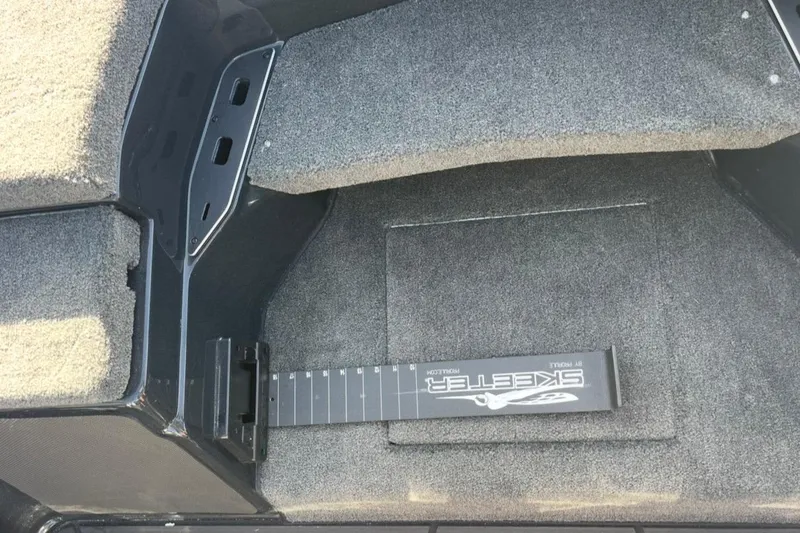 Slide: The Image of Interior of 2026 Skeeter FXR20 FLEX boat with carpeted flooring and measuring board. - 21