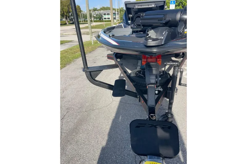 Slide: The Image of 2026 Skeeter FXR20 FLEX boat trailer hitch and bow view in parking lot. - 23