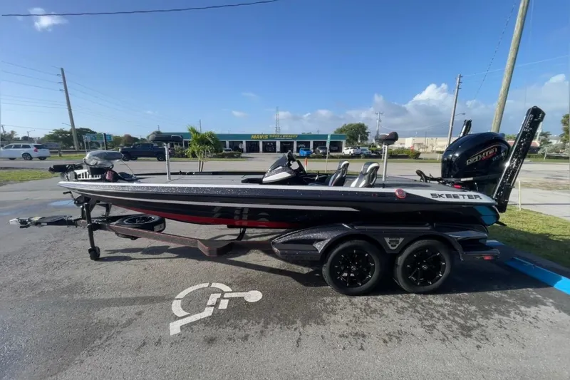 Slide: The Image of 2026 Skeeter FXR20 FLEX bass boat parked outdoors on a sunny day. - 3