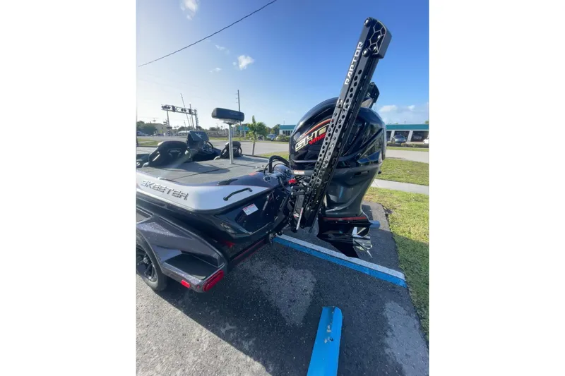 Slide: The Image of 2026 Skeeter FXR20 FLEX boat with powerful outboard motor in parking lot. - 4