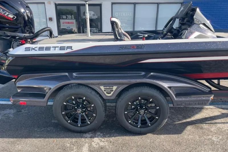 Slide: The Image of 2026 Skeeter FXR20 FLEX boat on trailer, featuring sleek design and modern wheels. - 6