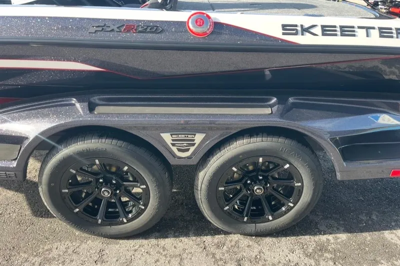 Slide: The Image of 2026 Skeeter FXR20 FLEX boat trailer with black alloy wheels and sleek design. - 9
