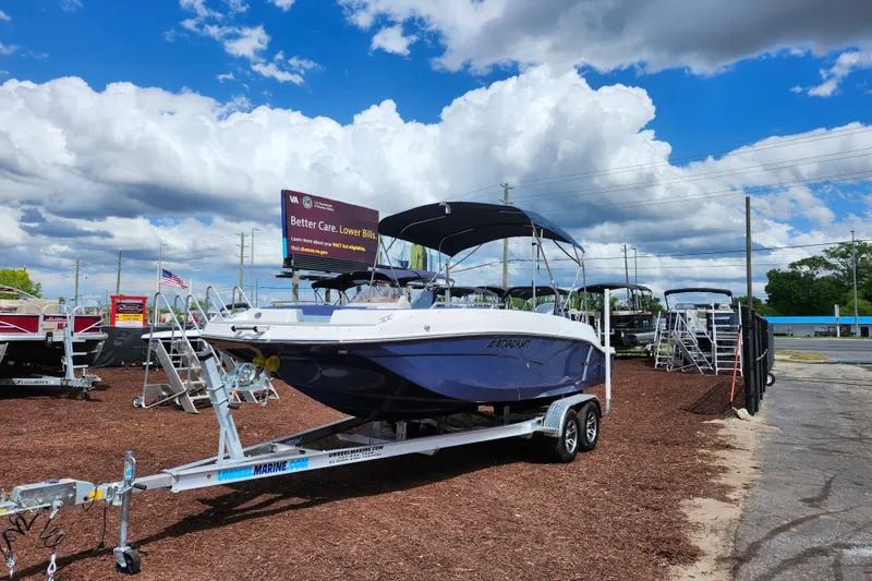 The Image of 2026 Starcraft SVX 211 OB boat on trailer under cloudy sky at dealership. - 1