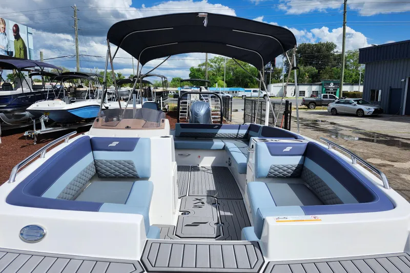 Slide: The Image of 2026 Starcraft SVX 211 OB boat with spacious seating and sleek design in a showroom. - 10