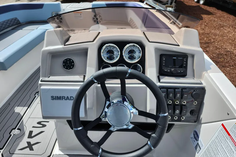 Slide: The Image of 2026 Starcraft SVX 211 OB boat dashboard with steering wheel and control panel. - 16