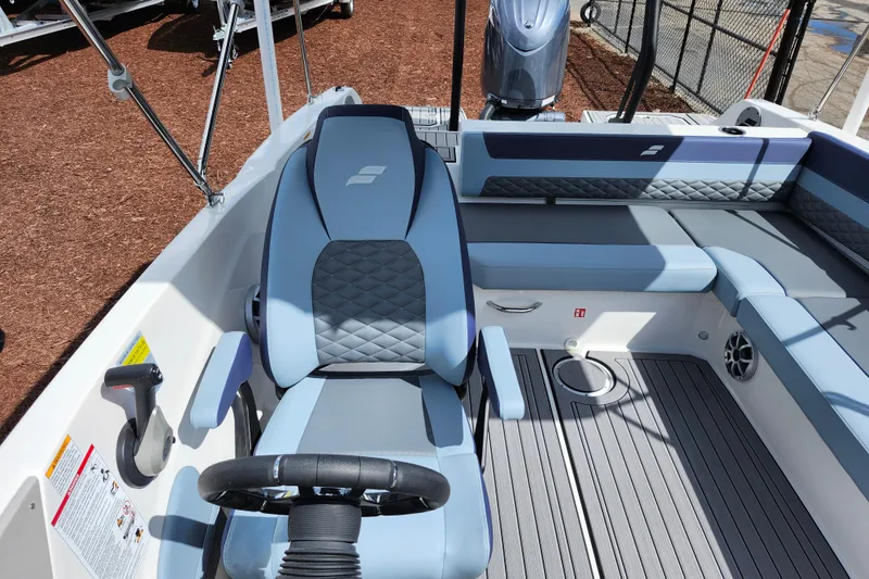 Slide: The Image of Interior of 2026 Starcraft SVX 211 OB boat with modern seating and steering wheel. - 17