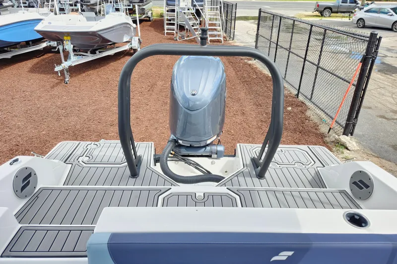 Slide: The Image of 2026 Starcraft SVX 211 OB boat with outboard motor, displayed in a showroom. - 19