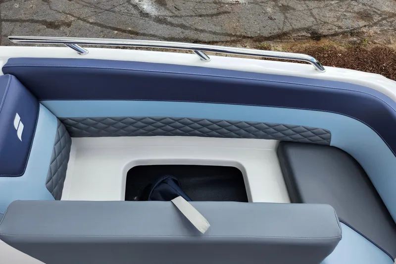 Slide: The Image of 2026 Starcraft SVX 211 OB boat interior with blue and gray cushioned seating. - 21