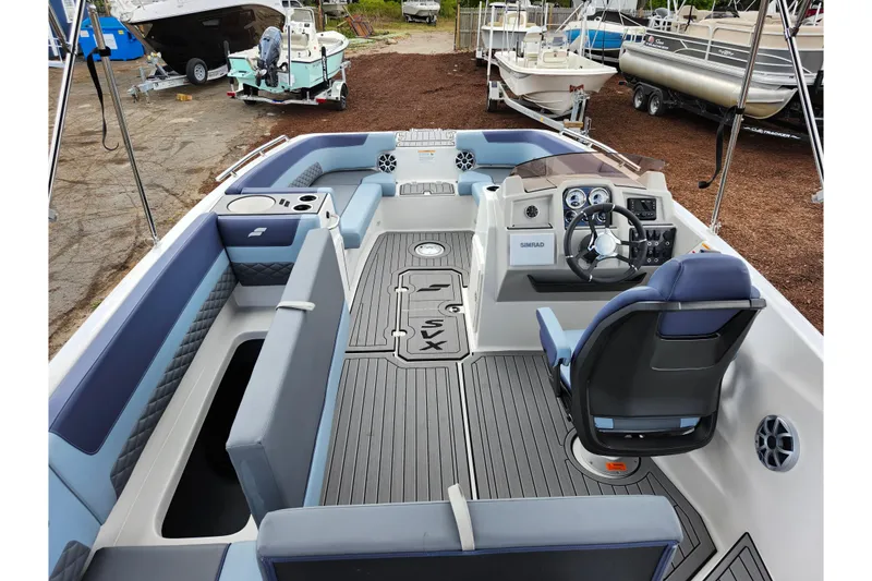 Slide: The Image of 2026 Starcraft SVX 211 OB boat interior with modern seating and steering console. - 24