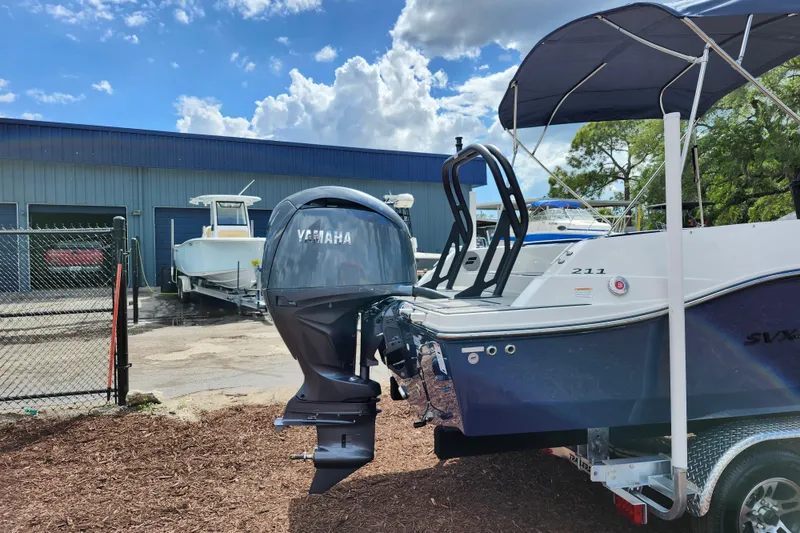 Slide: The Image of 2026 Starcraft SVX 211 OB boat with Yamaha outboard motor in a marina setting. - 8