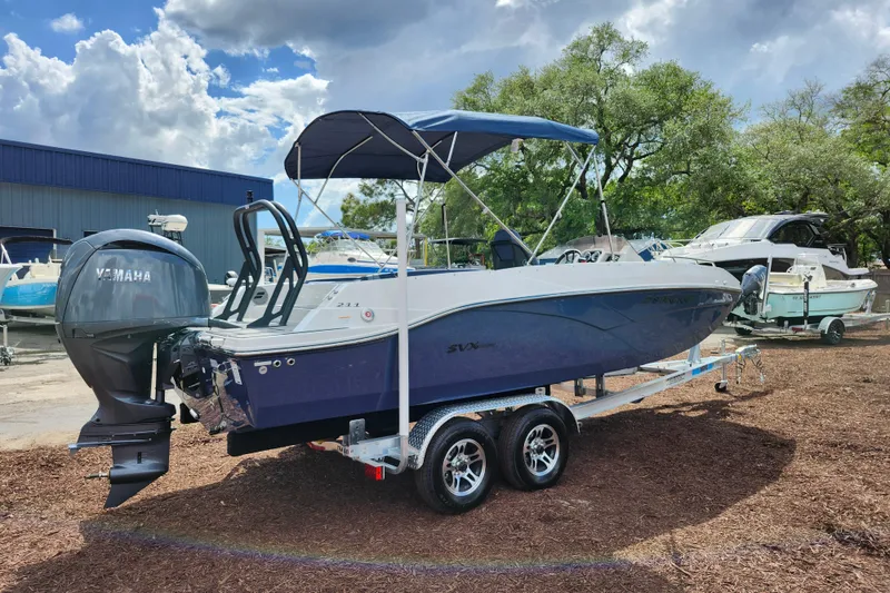 Slide: The Image of 2026 Starcraft SVX 211 OB boat with Yamaha engine on trailer, parked outdoors. - 9