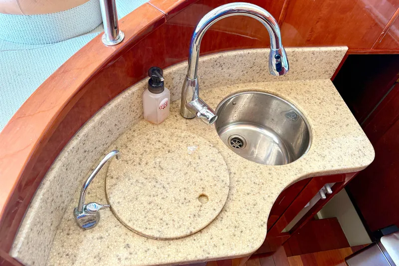 Slide: The Image of Luxury yacht Fairline Squadron 55, 2000 model, featuring elegant kitchen sink area. - 13