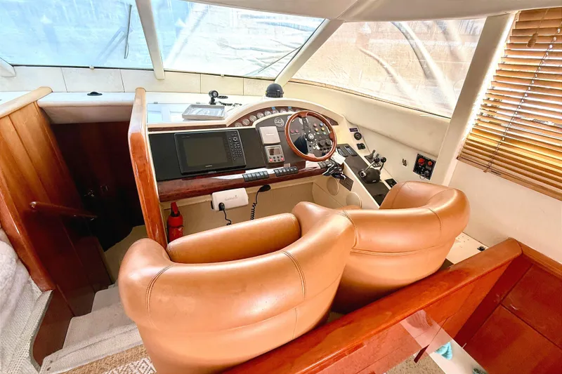Slide: The Image of Interior helm of 2000 Fairline Squadron 55 yacht with leather seating and navigation controls. - 7