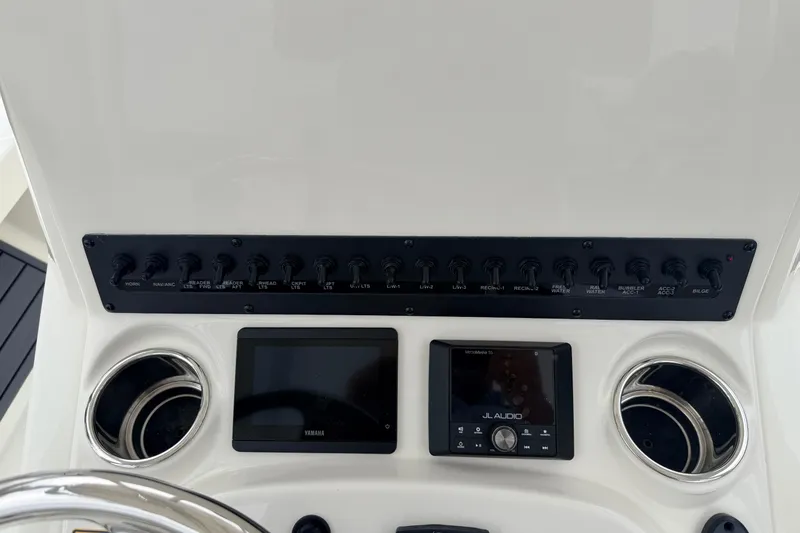 Slide: The Image of Control panel of 2026 Pathfinder 2200 TRS boat with switches and audio system. - 12