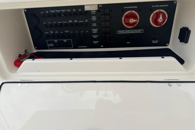 Slide: The Image of Control panel of a 2026 Pathfinder 2200 TRS boat, featuring switches and circuit breakers. - 17