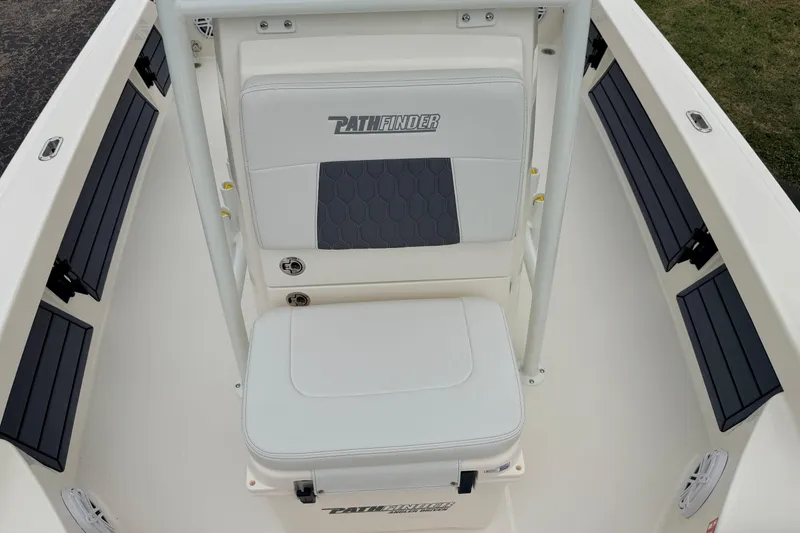 Slide: The Image of 2026 Pathfinder 2200 TRS boat interior with cushioned seating and storage. - 19