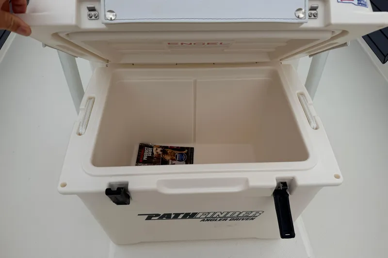 Slide: The Image of Open cooler on Pathfinder 2200 TRS boat, showcasing spacious interior with a magazine inside. - 20