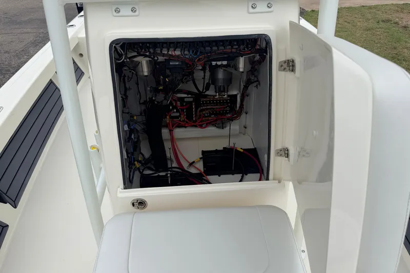 Slide: The Image of Open electrical compartment of 2026 Pathfinder 2200 TRS boat, showing wiring and components. - 21