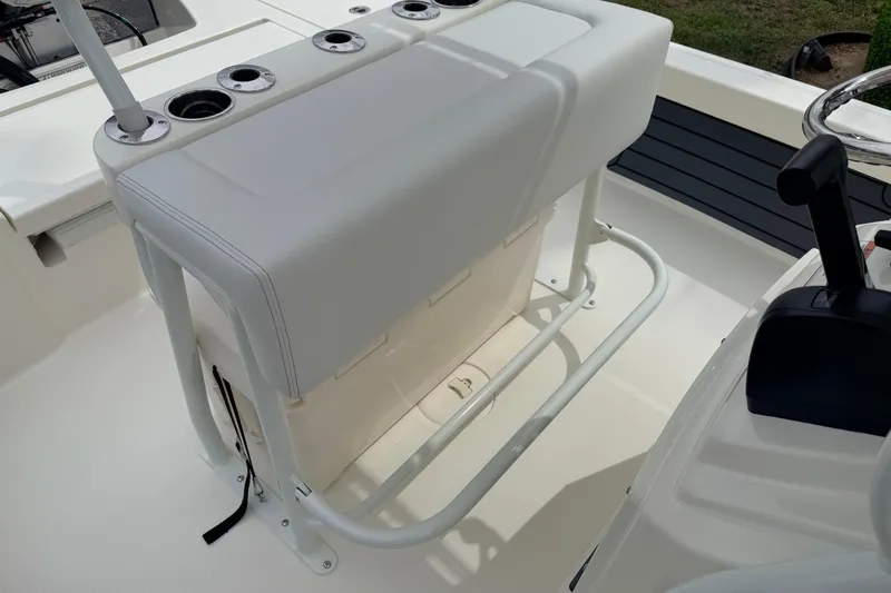 Slide: The Image of 2026 Pathfinder 2200 TRS boat seating area with rod holders and storage. - 24