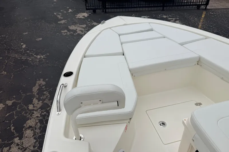 Slide: The Image of 2026 Pathfinder 2200 TRS boat interior with white cushioned seating and storage compartments. - 31