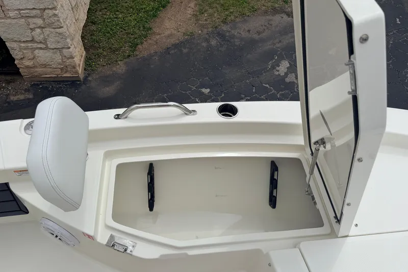 Slide: The Image of 2026 Pathfinder 2200 TRS boat storage compartment with open hatch and cushioned seat. - 36