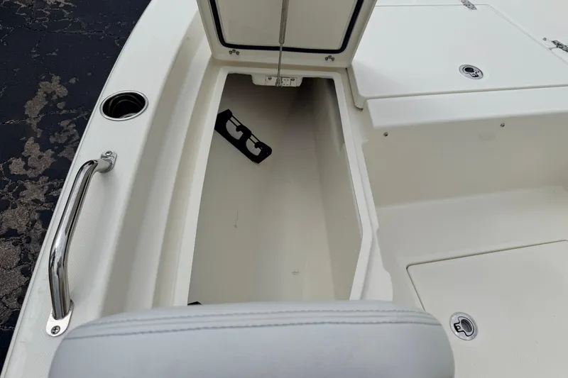 Slide: The Image of 2026 Pathfinder 2200 TRS boat storage compartment with open hatch and stainless steel handle. - 37