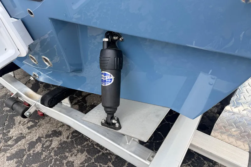 Slide: The Image of 2026 Pathfinder 2200 TRS boat detail showing trim tab and trailer components. - 4