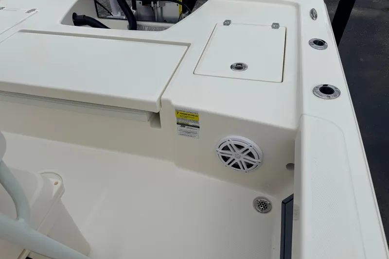 Slide: The Image of 2026 Pathfinder 2200 TRS boat interior with storage compartments and speaker. - 48