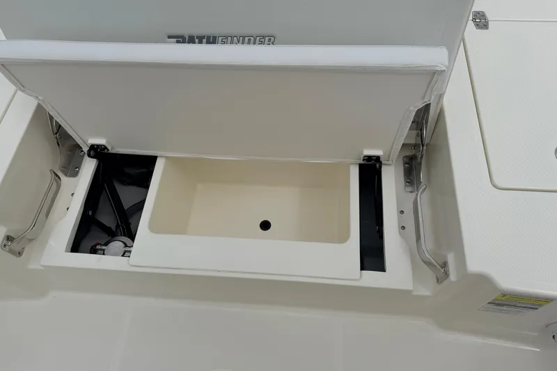 Slide: The Image of 2026 Pathfinder 2200 TRS boat storage compartment with open lid, showcasing interior space. - 50