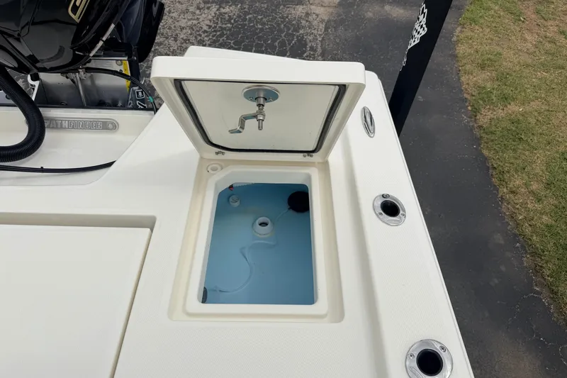 Slide: The Image of 2026 Pathfinder 2200 TRS boat livewell with open lid, showcasing interior and fittings. - 53