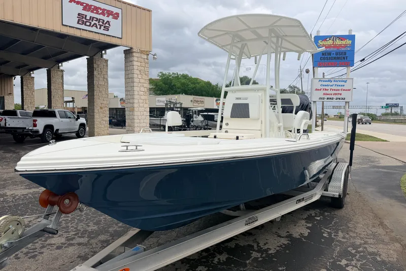 Slide: The Image of 2026 Pathfinder 2200 TRS boat on trailer at dealership, showcasing sleek design and modern features. - 9