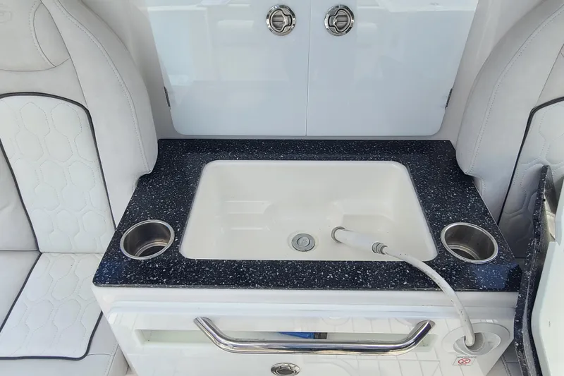 Slide: The Image of Luxury sink area on 2022 Sea Fox 368 Commander boat with sleek design and cup holders. - 13