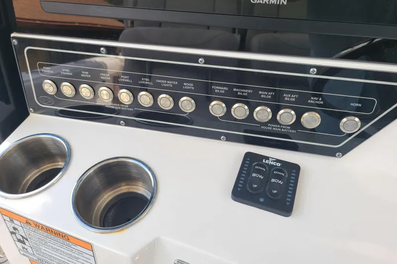 Slide: The Image of Control panel of 2022 Sea Fox 368 Commander boat with labeled buttons and cup holders. - 23