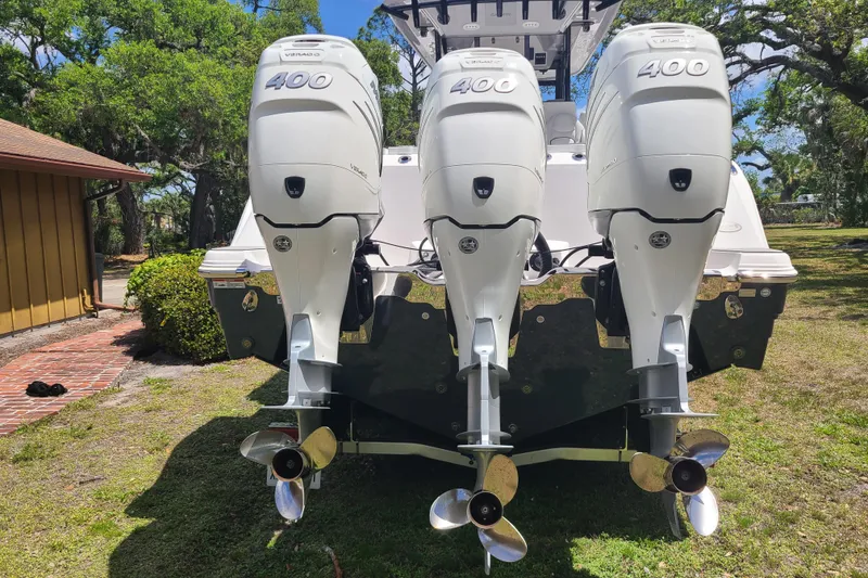 Slide: The Image of 2022 Sea Fox 368 Commander with triple 400 horsepower outboard engines, parked outdoors. - 3