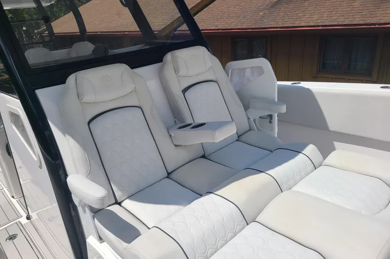 Slide: The Image of Luxurious seating on 2022 Sea Fox 368 Commander boat, featuring white cushioned seats and armrests. - 37