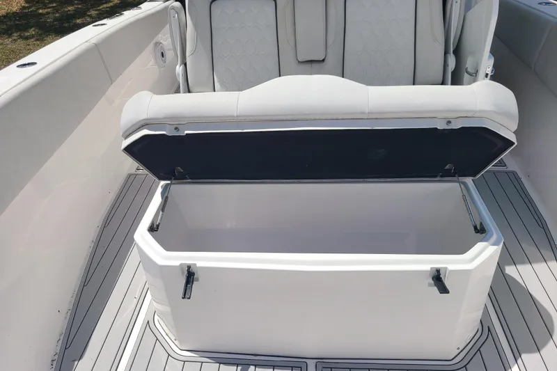 Slide: The Image of Open storage compartment on 2022 Sea Fox 368 Commander boat, featuring cushioned seating. - 38