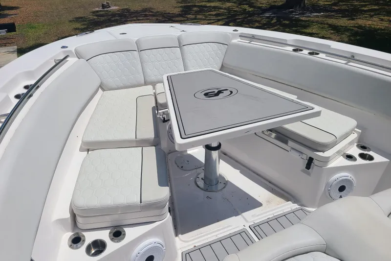 Slide: The Image of Luxurious seating area on a 2022 Sea Fox 368 Commander boat with a central table. - 43