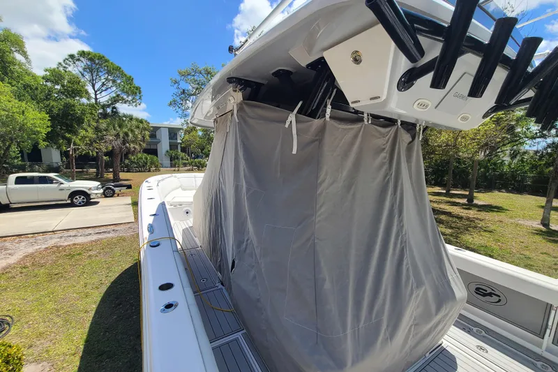 Slide: The Image of 2022 Sea Fox 368 Commander boat with covered console, parked outdoors under a clear sky. - 47