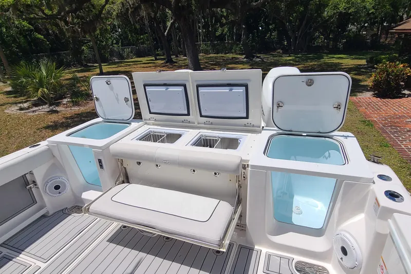 Slide: The Image of 2022 Sea Fox 368 Commander boat interior with open storage compartments and seating. - 7