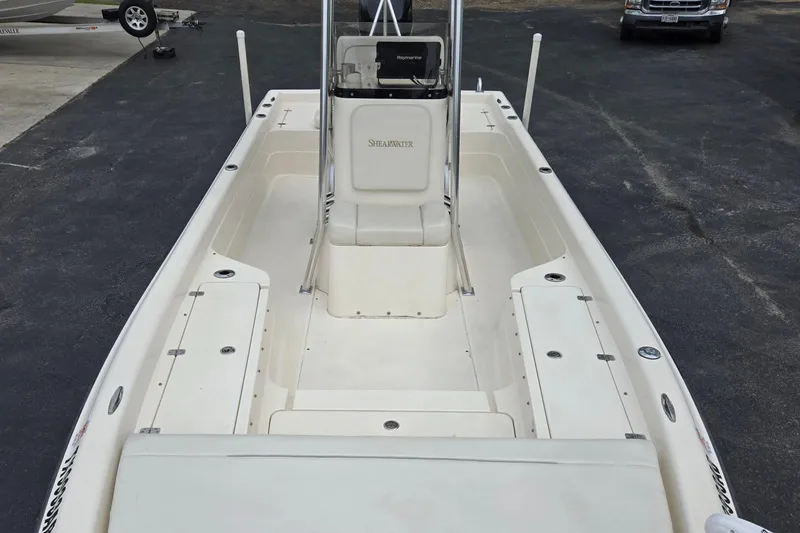 Slide: The Image of 2006 ShearWater 2400Z boat interior, featuring spacious deck and center console. - 12