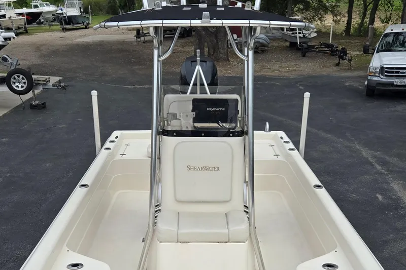 Slide: The Image of 2006 ShearWater 2400Z boat with center console and Raymarine electronics, parked outdoors. - 13