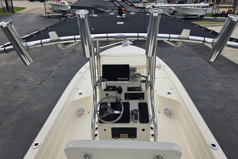 Slide: The Image of Center console of a 2006 ShearWater 2400Z boat with steering wheel and electronics. - 17