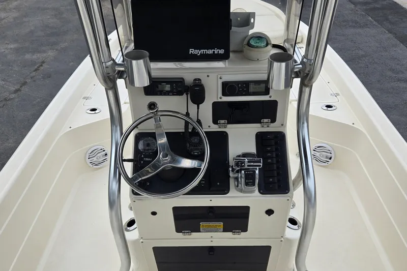 Slide: The Image of Center console of a 2006 ShearWater 2400Z boat with steering wheel and controls. - 18