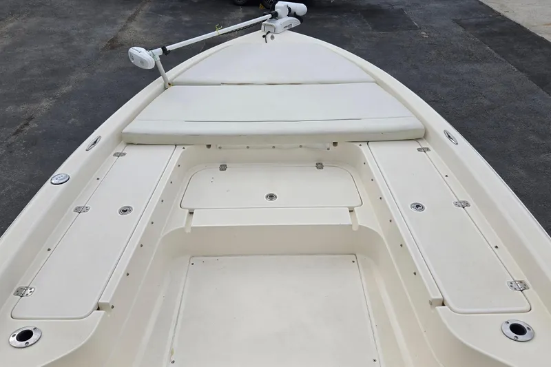 Slide: The Image of 2006 ShearWater 2400Z boat deck with storage compartments and trolling motor. - 19