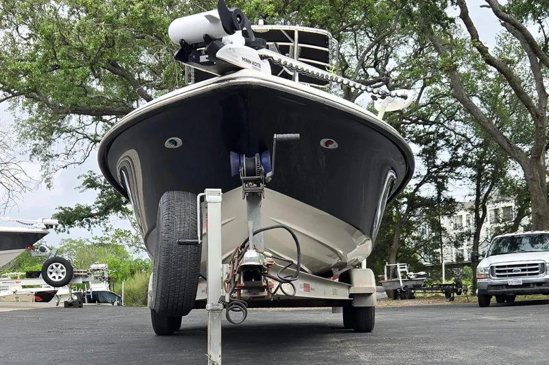 Slide: The Image of 2006 ShearWater 2400Z boat on trailer, parked outdoors with trees in background. - 9