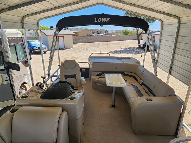 Slide: The Image of Interior of a 2015 Lowe SS210 pontoon boat under a carport. - 10