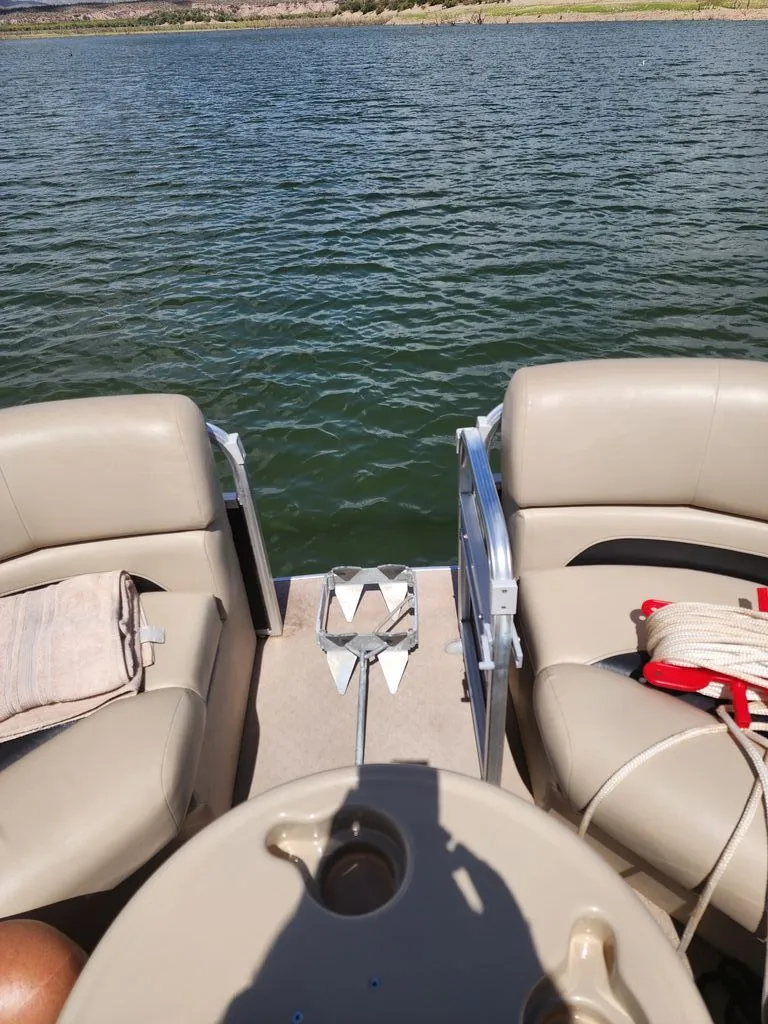 Slide: The Image of 2015 Lowe SS210 pontoon boat on a calm lake. - 11